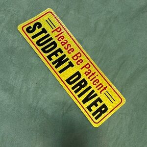 A sign “Student Driver”
